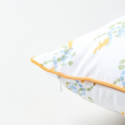 Green blue and orange swirl print detail on  whitecotton cushion cover showcasing block printing artistry