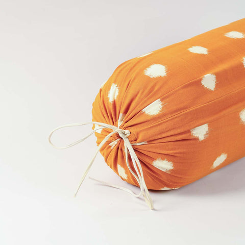 Detailed end view of a drawstring mustard cotton bolster cover featuring textured handwoven construction