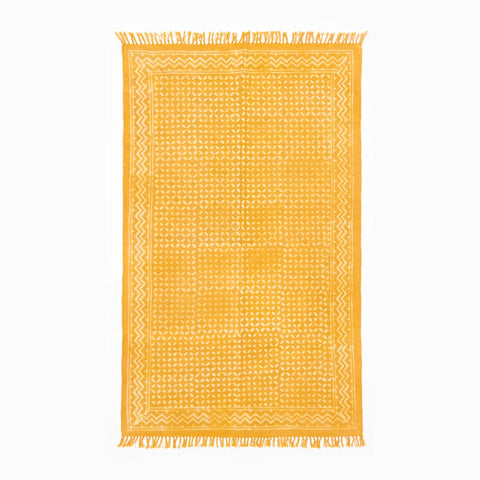 Handloom cotton dhurrie rug in mustard featuring geometric hand block printed patterns across the surface