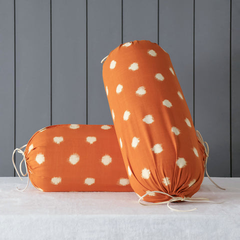 Mustard handwoven bolster cover set styled on a bed adding warmth texture and artisanal charm to home decor