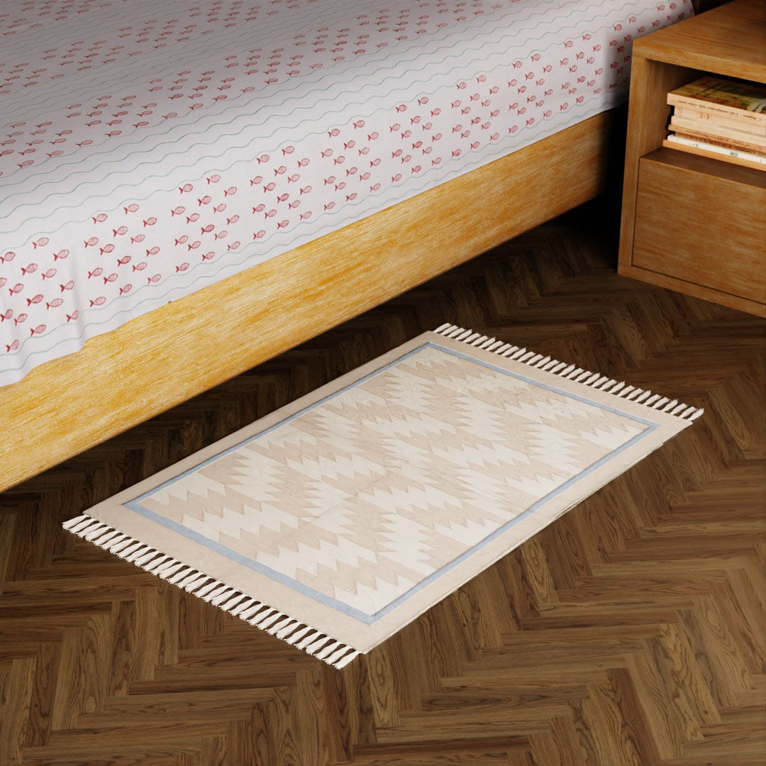 Off-white and beige geometric handwoven cotton dhurrie styled in a modern living space as an elegant floor accent