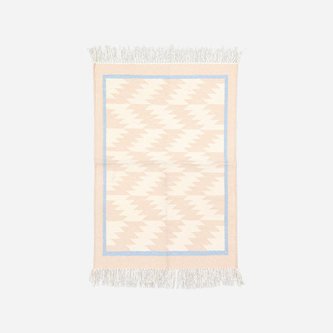 Full-size 2x3 ft handwoven cotton rug featuring repeating geometric patterns in off white and beige