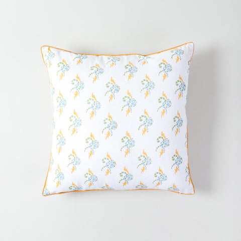 White cotton cushion cover featuring swirl patterns in orange,  green, and blue, and a neatly piped edge in orange