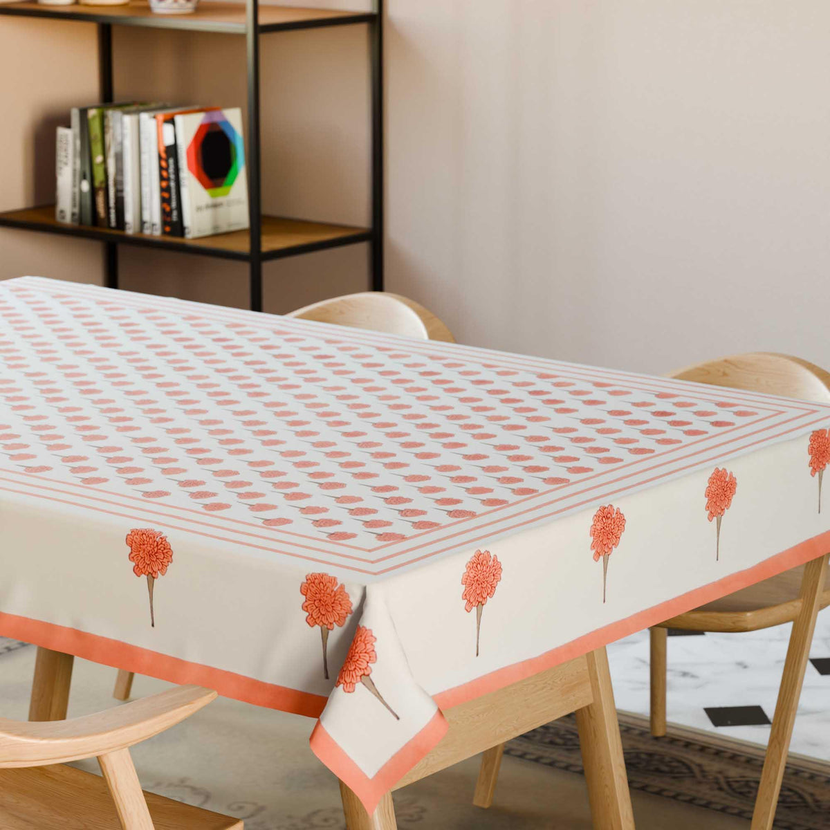 Orange marigold buti block printed cotton table cloth styled on a dining table with coordinated tableware and festive decor