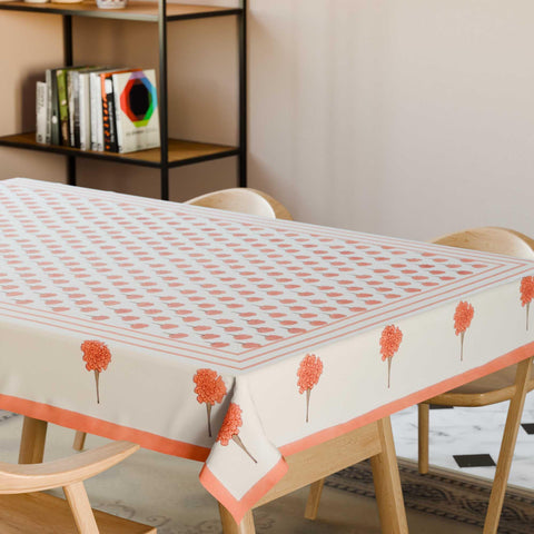 Orange marigold buti block printed cotton table cloth styled on a dining table with coordinated tableware and festive decor
