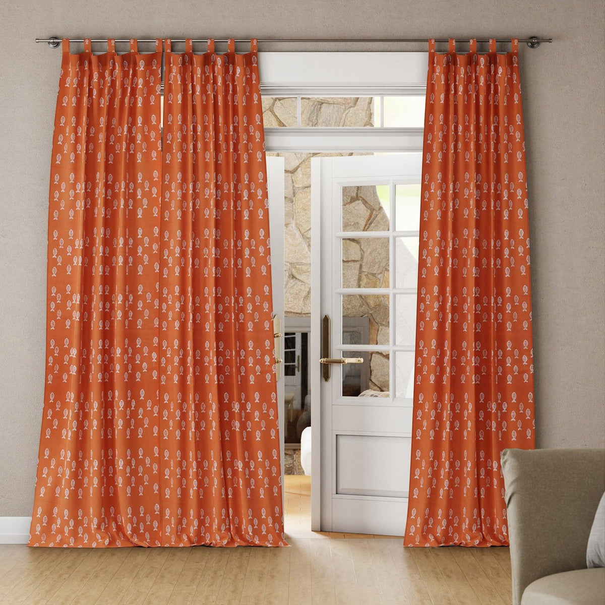 Bright living room with orange-rust tab top cotton curtains framing white French doors and allowing soft natural light
