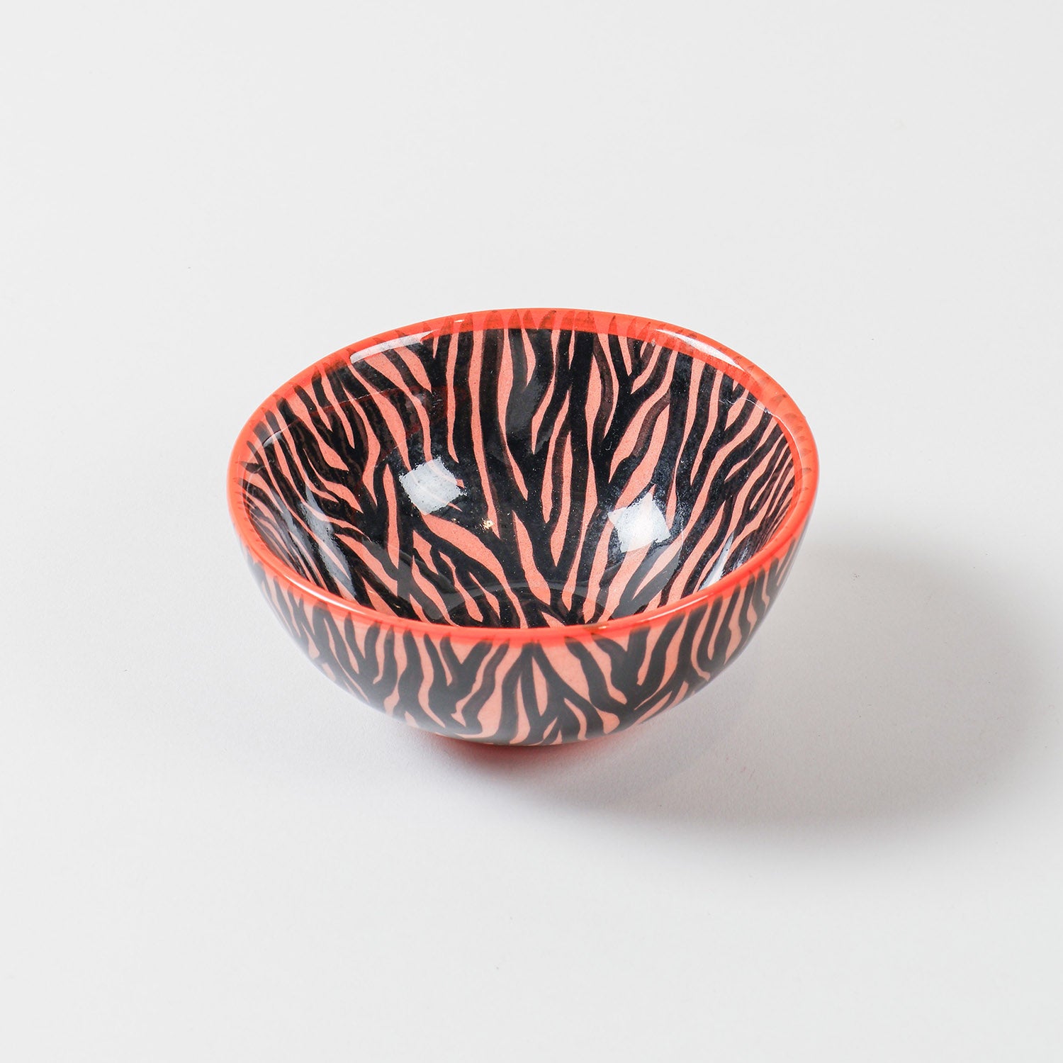Handpainted ceramic bowl with an orange background and bold black zebra pattern, perfect as a small bowl for snacks, desserts, sides, and everyday dining