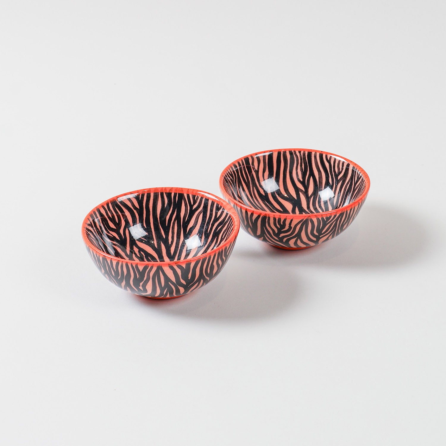 Zebra Pattern ceramic bowl set of 2 featuring a vibrant orange base with handpainted black zebra-inspired artwork, ideal as snack bowls, small serving bowls, and decorative tableware