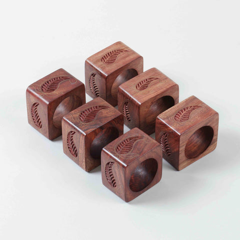 Set of six square wooden napkin rings featuring paisley engraving and handcrafted brass inlay detailing