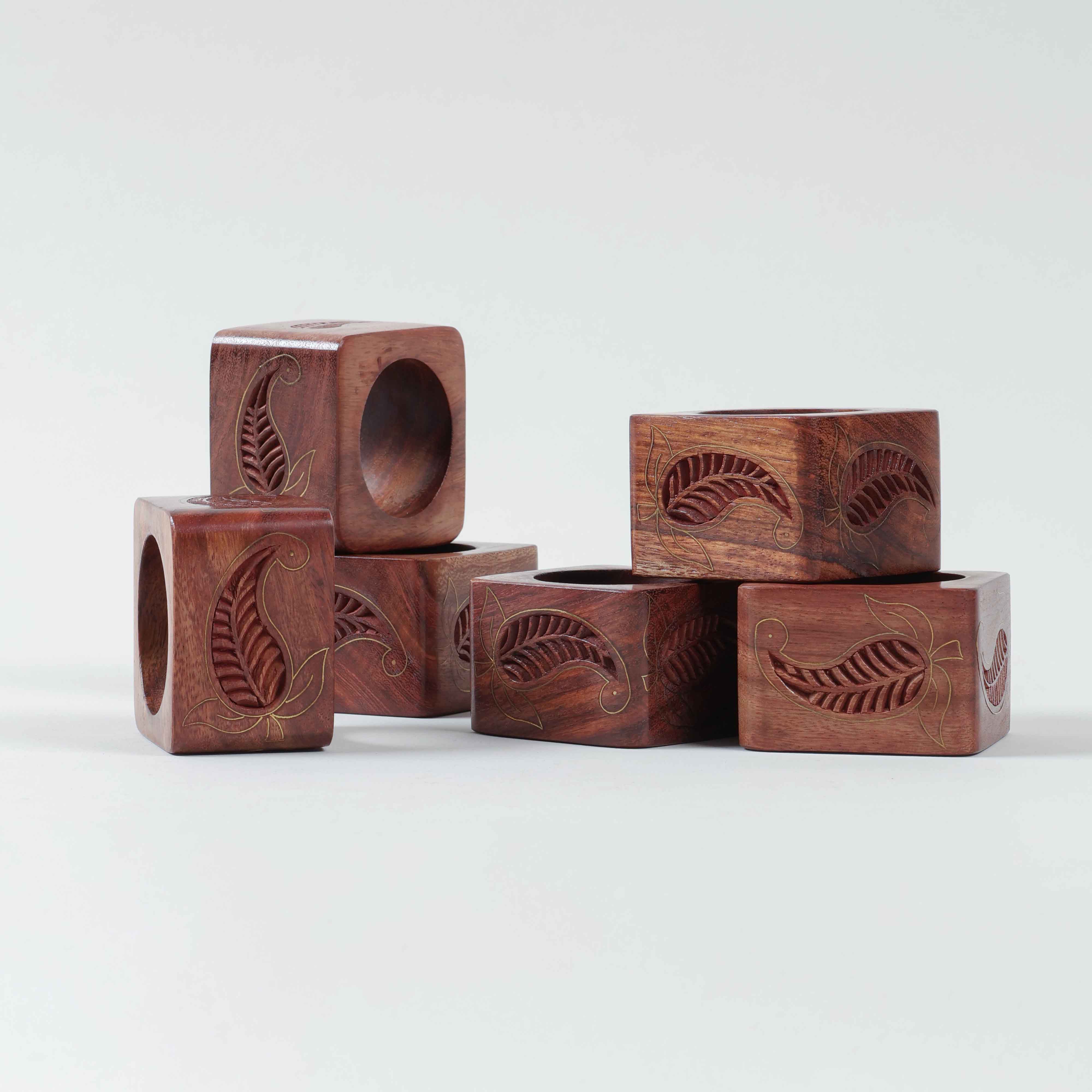 Side view of six Sheesham wood napkin rings showcasing square shape and decorative brass detailing