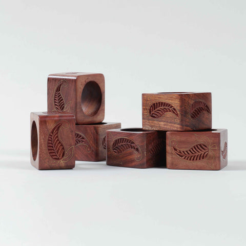 Side view of six Sheesham wood napkin rings showcasing square shape and decorative brass detailing