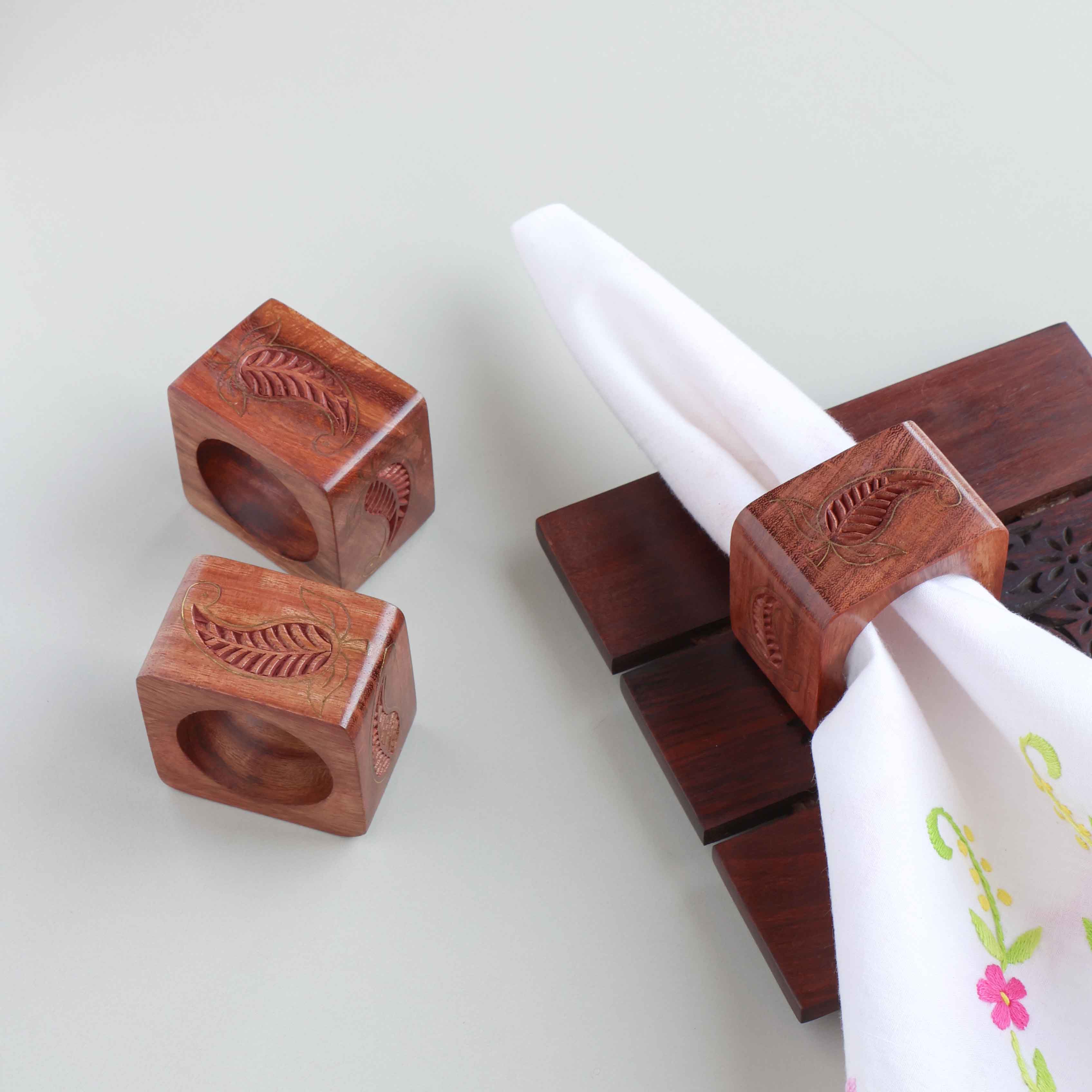 Paisley wooden napkin rings with brass inlay styled on a dining table for an elegant table setting decor