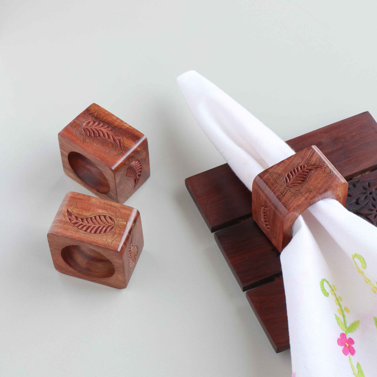 Paisley wooden napkin rings with brass inlay styled on a dining table for an elegant table setting decor
