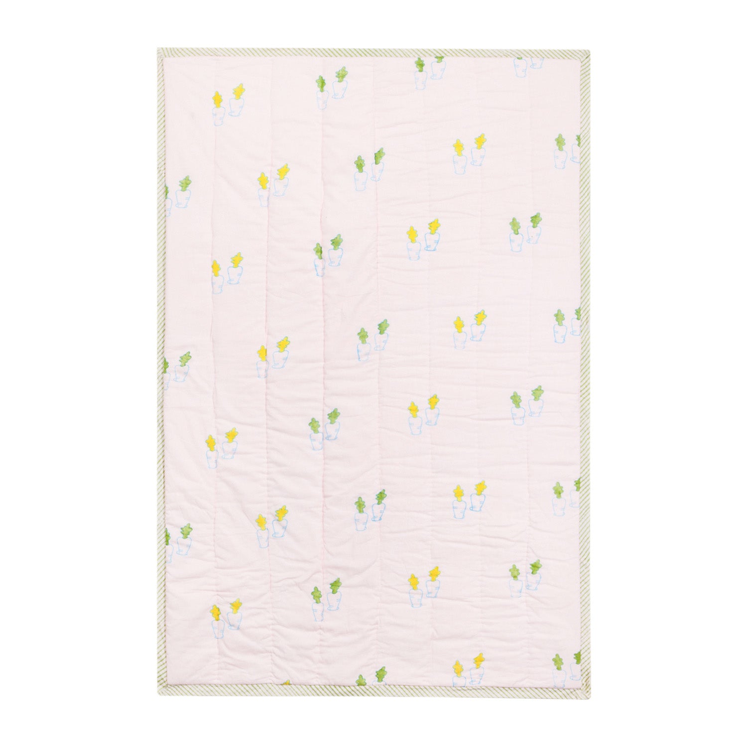 Back side of a hand block printed cotton quilt with coordinating bunny and carrot patterns in soft pastel colours
