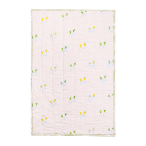 Back side of a hand block printed cotton quilt with coordinating bunny and carrot patterns in soft pastel colours