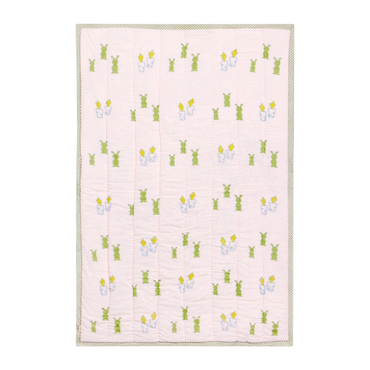 Full view of a 60x40 reversible cotton quilt with pastel bunny and carrot motifs on a light pink base
