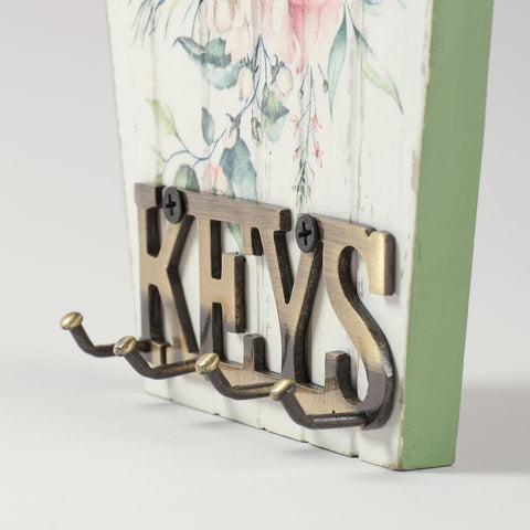 Detailed view of pink floral decoupage artwork on a bamboo key holder showcasing traditional handmade craftsmanship from Nagaland