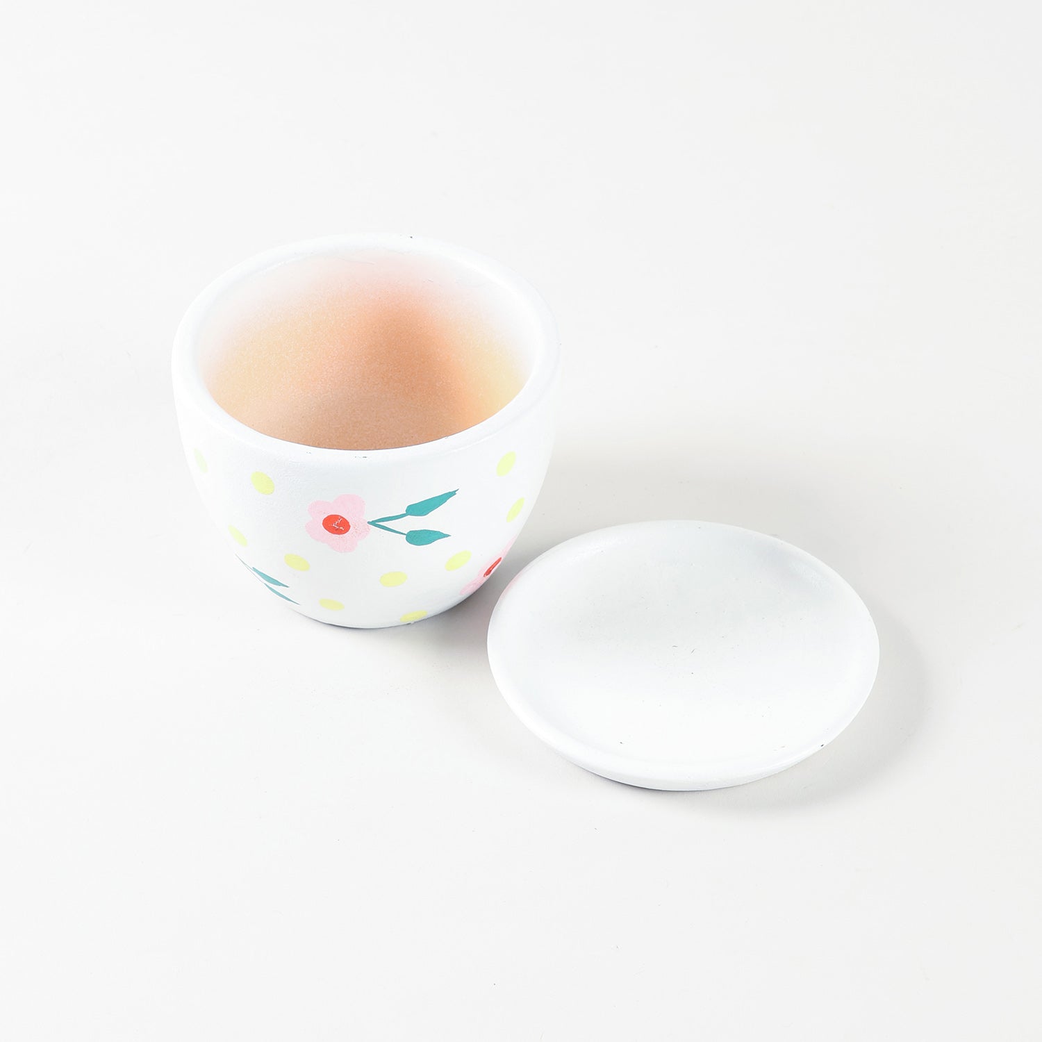 Pink blossom ceramic planter with its tray shown from high angle highlighting floral detailing and compact form.
