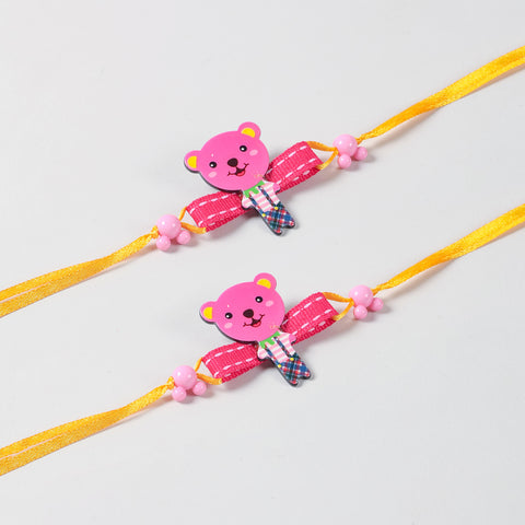 Close-up of the handmade pink cartoon Teddy Bear Wooden Kids Rakhi Set of 2, highlighting the colourful wooden teddy design and yellow ribbon details.