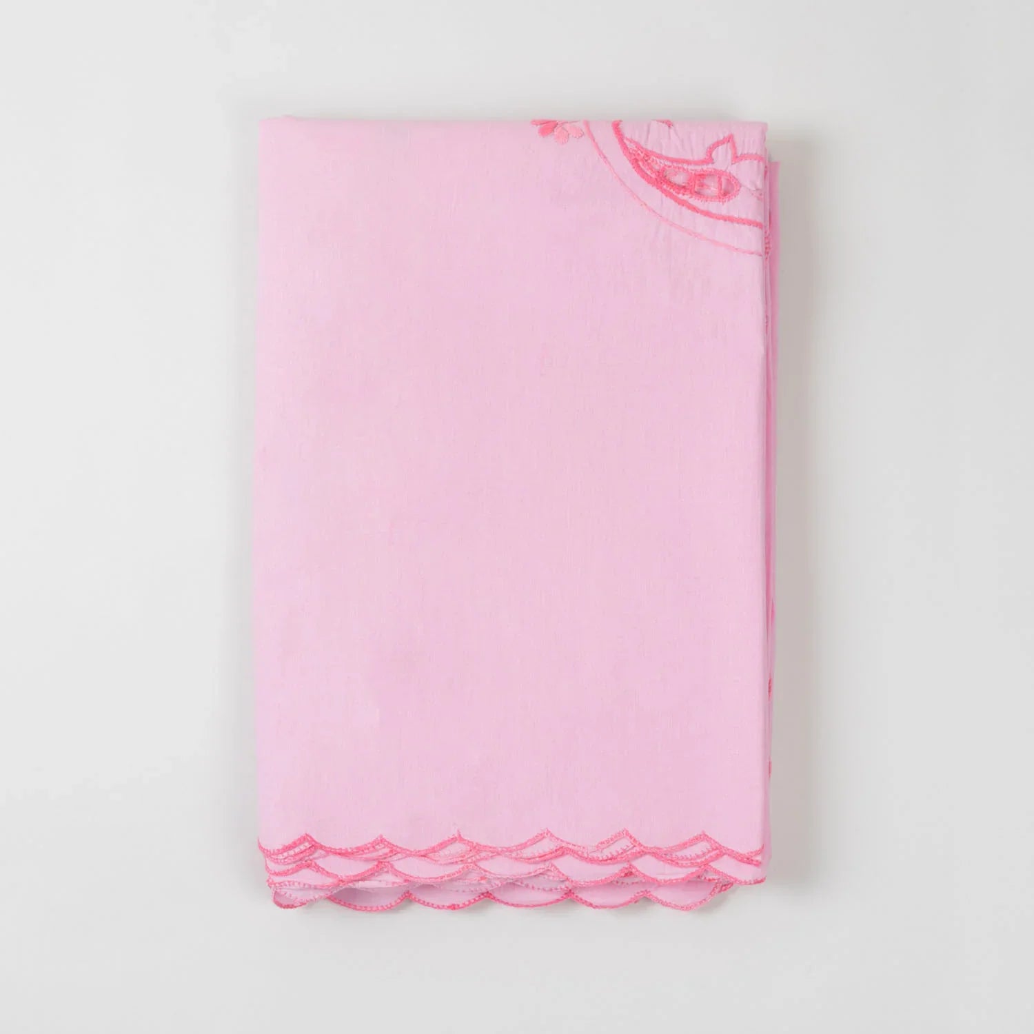 Folded pink cotton king-size bedcover showcasing dark pink chikankari hand embroidery and cotton texture