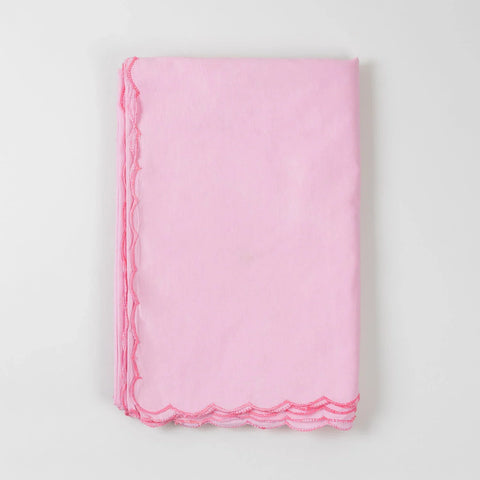 Folded pink cotton king-size bedcover showcasing soft fabric texture