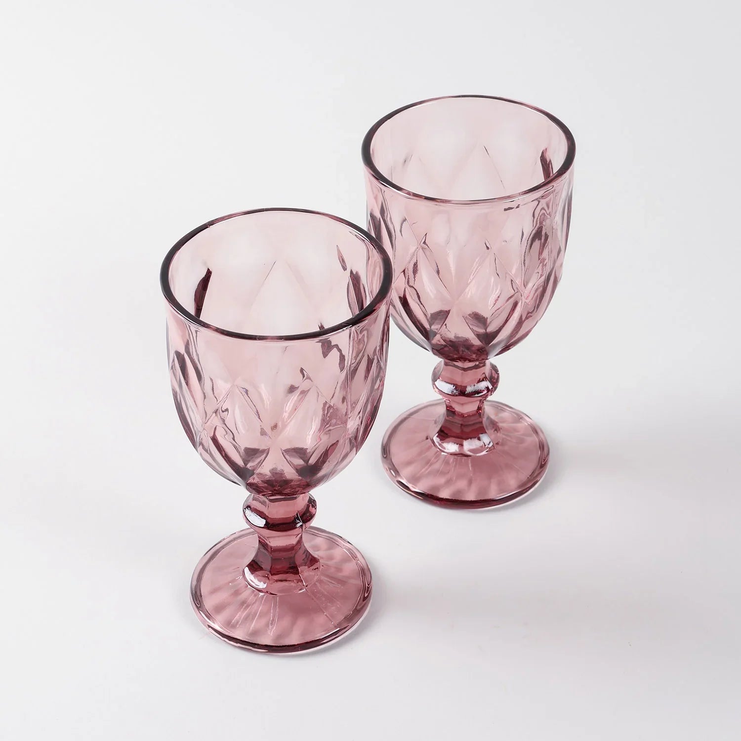 Set of two pink diamond wine glasses displayed against a clean background highlighting handcrafted glasswork