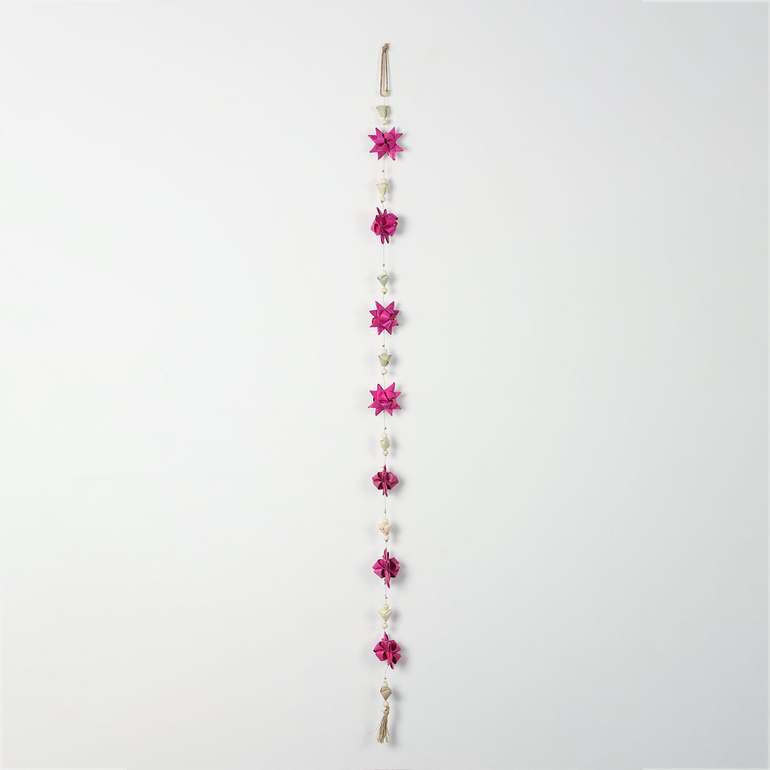 Decorative bead and pearl accents on a pink floral door hanging