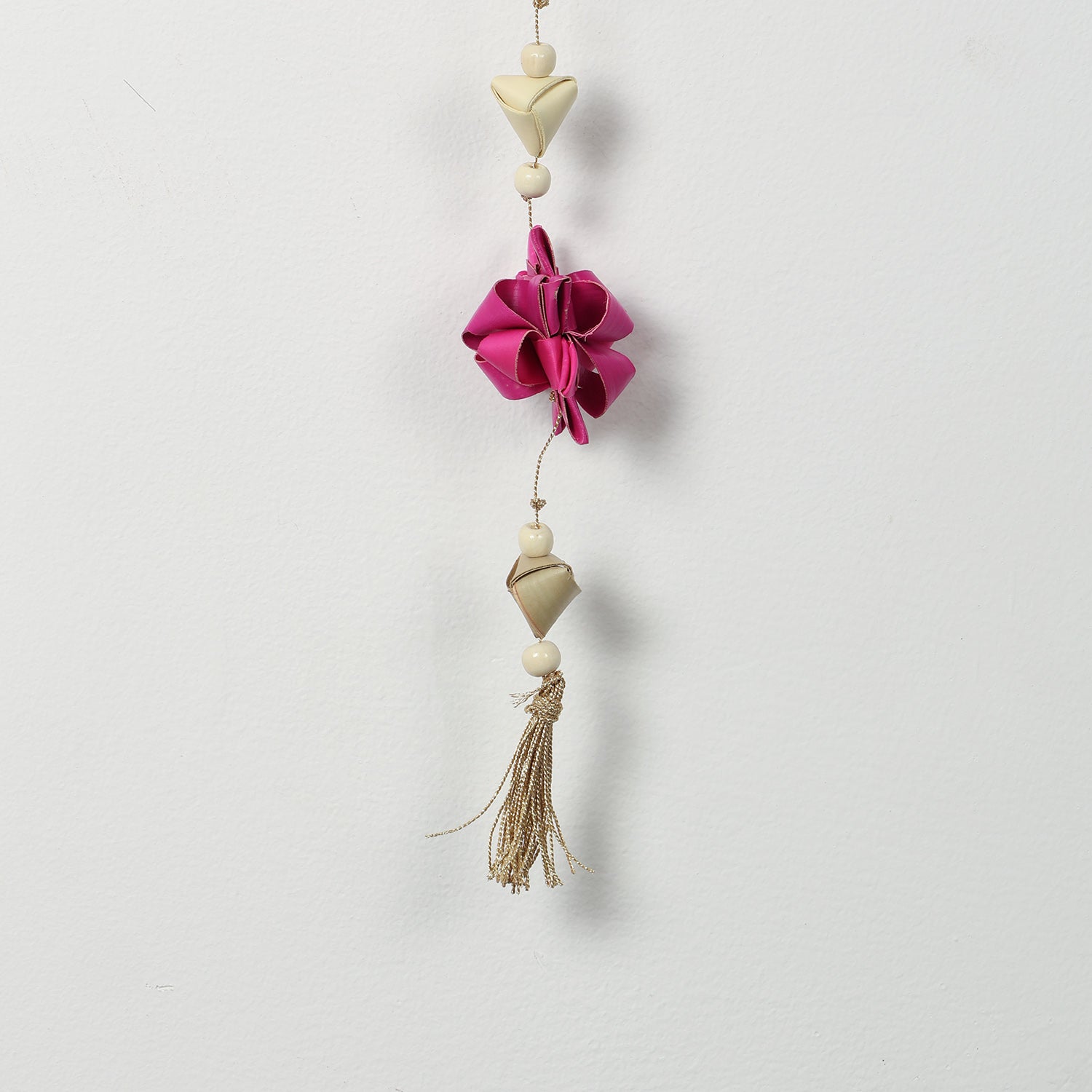 Close-up of pink folded paper star flowers on a decorative hanging