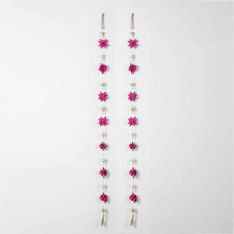 Full view of pink origami-style flower door hanging with decorative beads