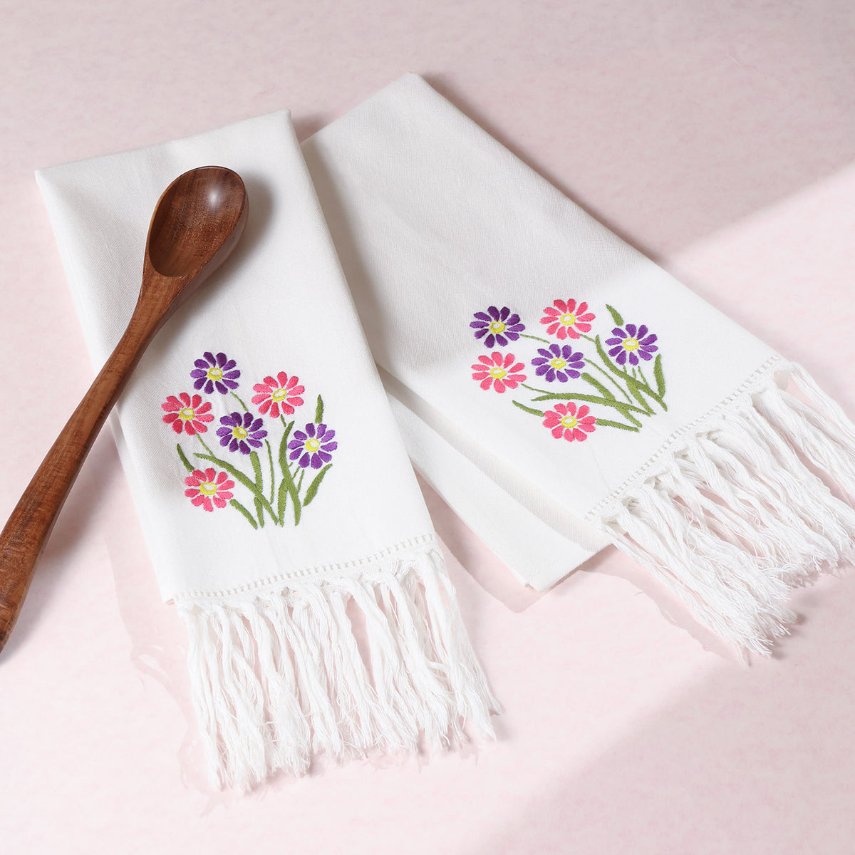 Pink and purple daisy embroidered cotton kitchen towels styled with kitchen accessories for charming kitchen decor