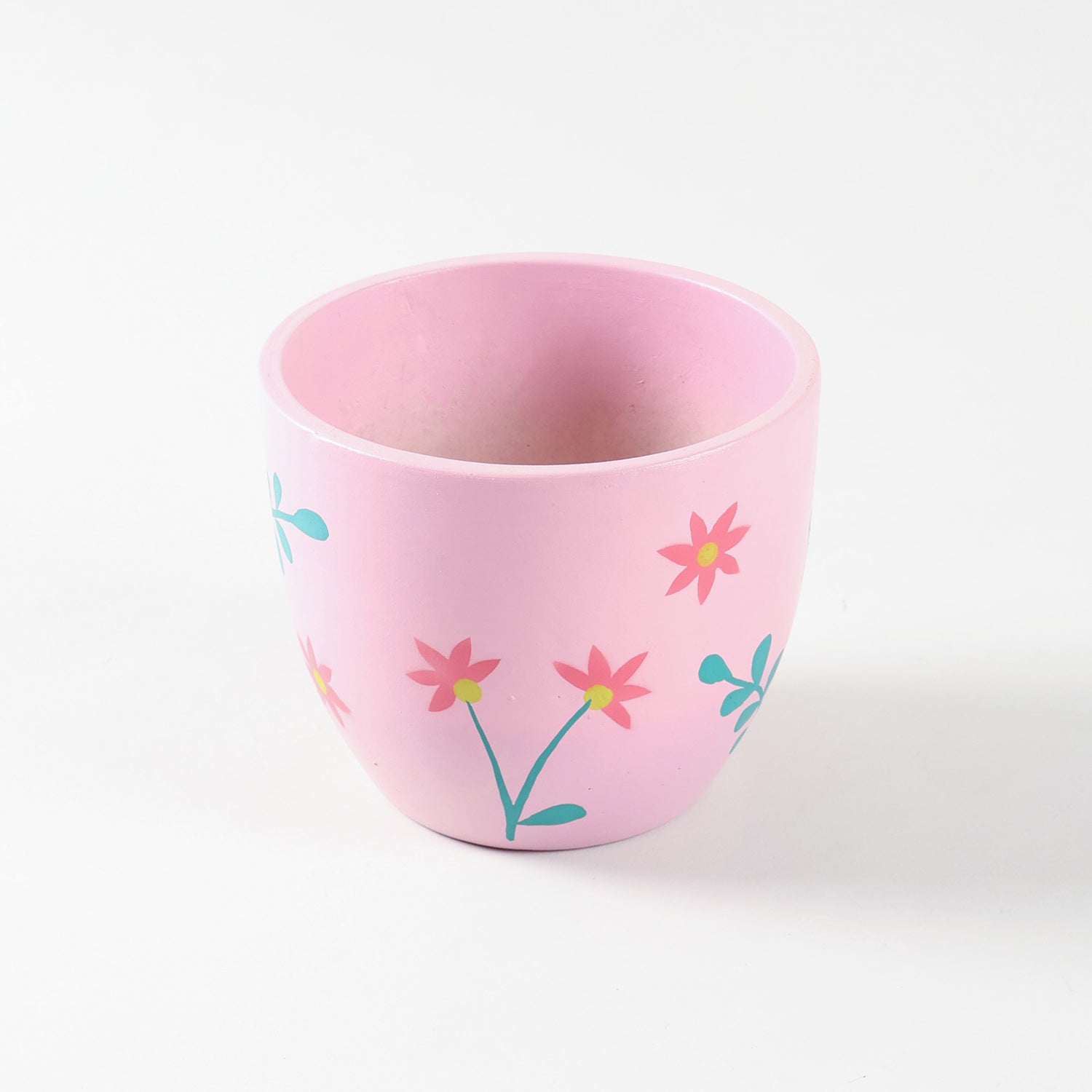 Pink floral ceramic planter shown in high angled view highlighting scattered floral pattern.