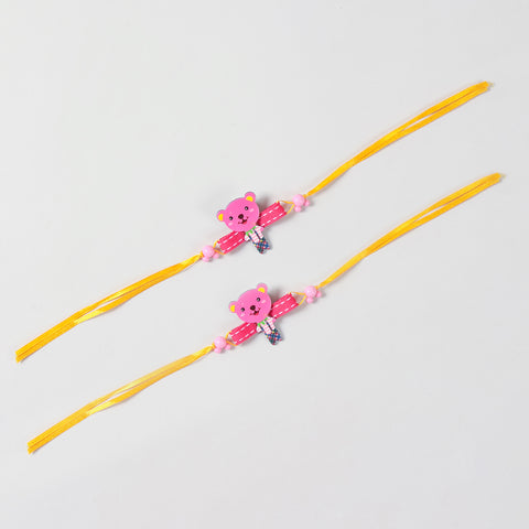 Full-length view of the pink Teddy Bear Wooden Kids Rakhi Set of 2 showing the complete yellow ribbon band and handcrafted wooden teddy design.