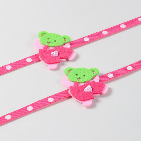 Close-up view of the handmade pink Teddy Bear Felt Kids Rakhi highlighting its soft felt design and colourful details.