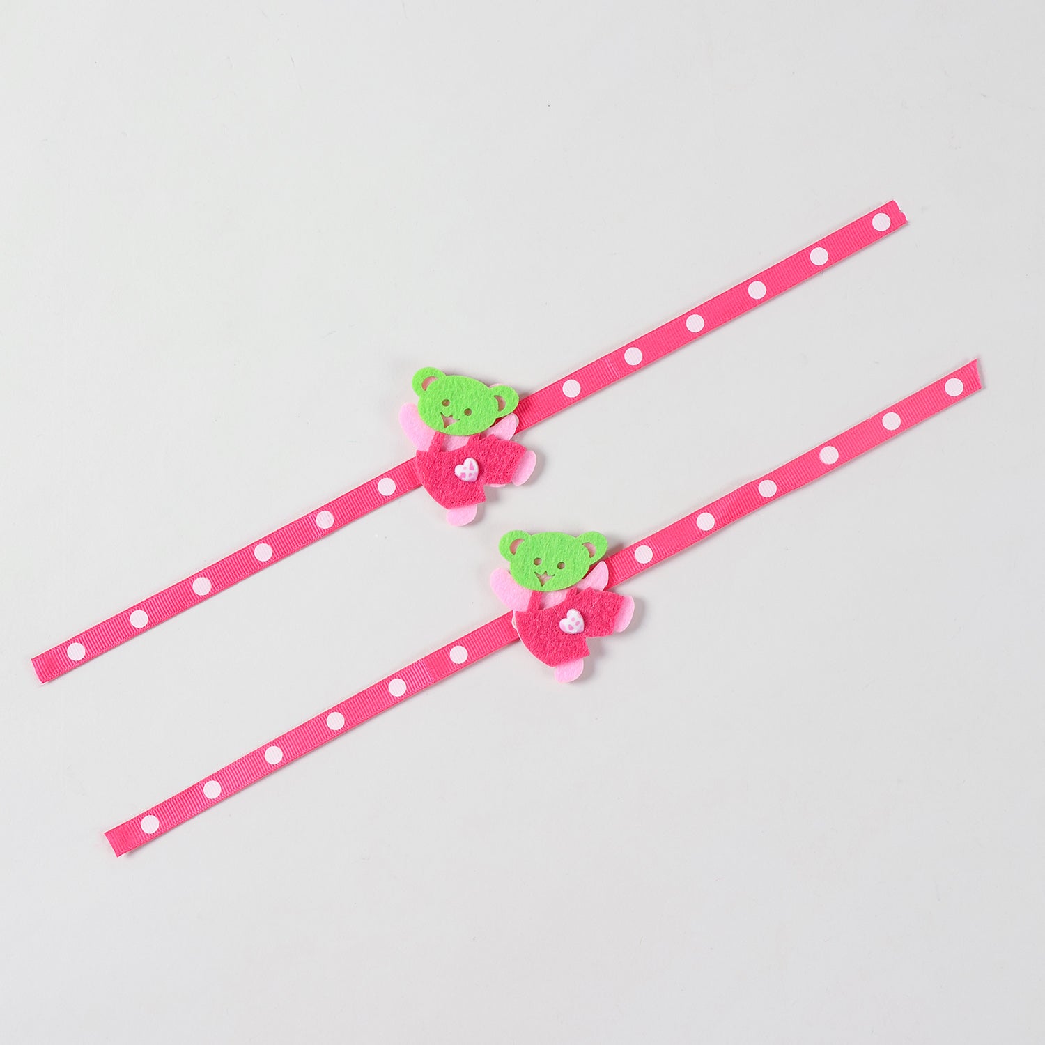 Full-length view of the pink Teddy Bear Felt Rakhi Kids Set of 2 showing the complete ribbon band and handcrafted teddy bear design.