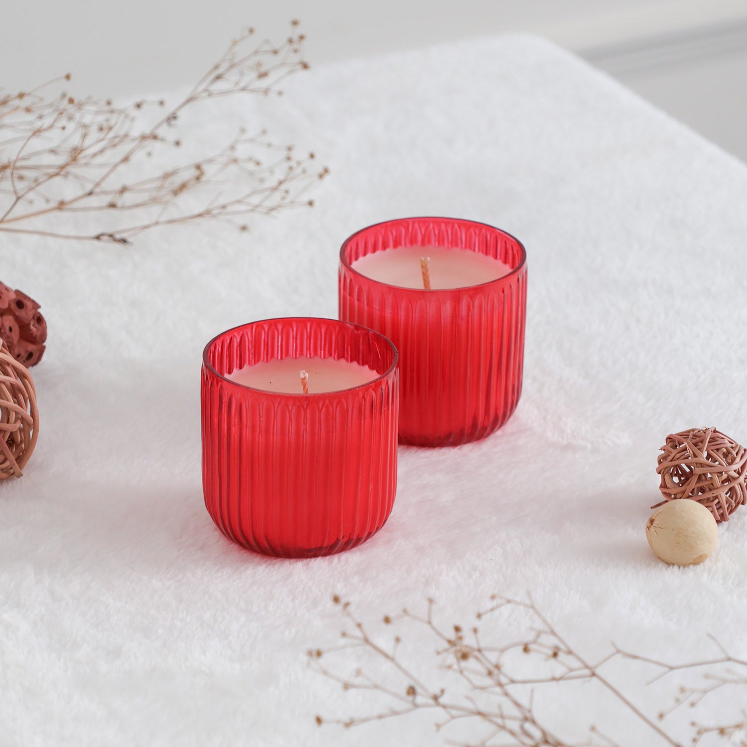 Apple cinnamon scented glass candles styled on a dining table creating a warm festive ambience for home decor
