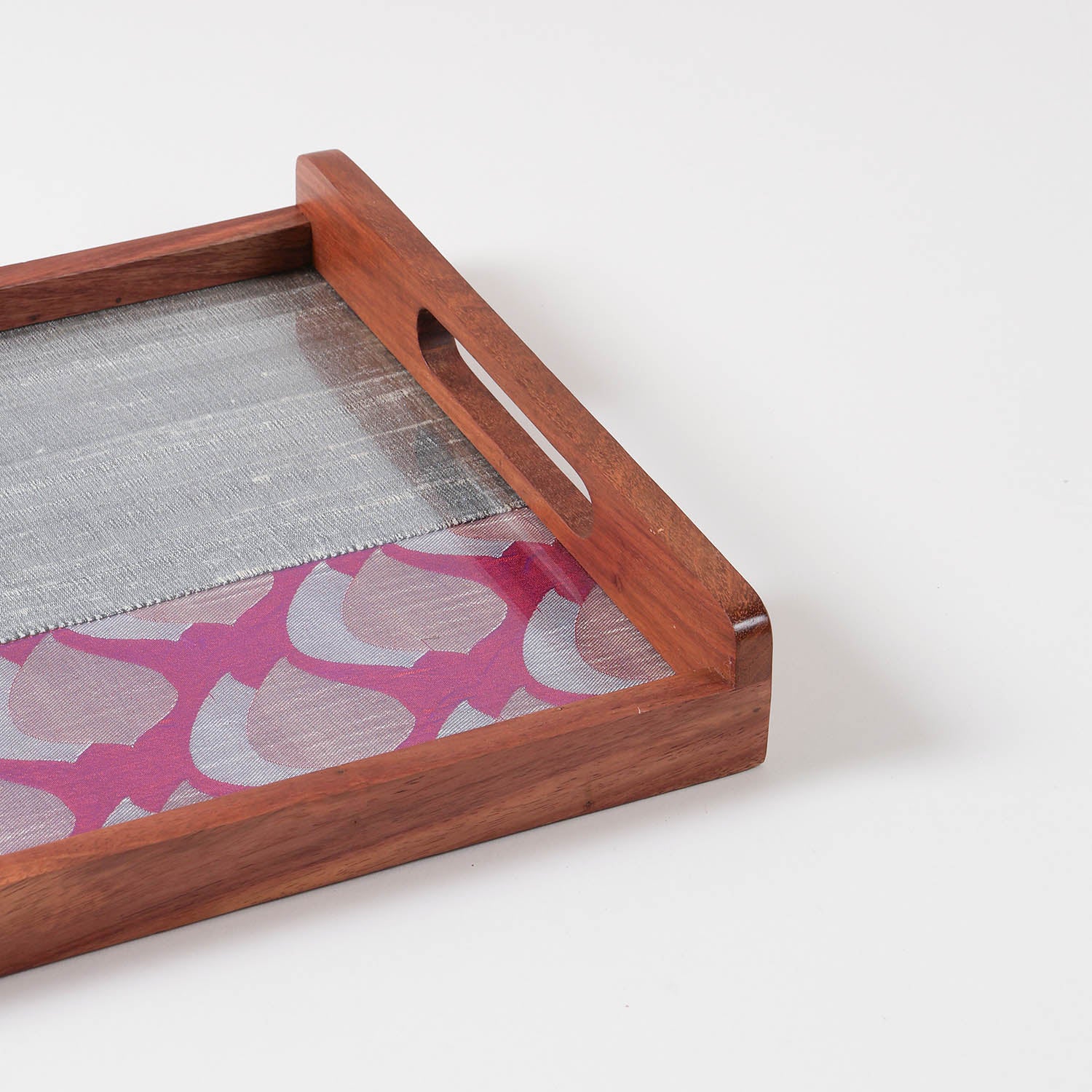 Close-up of purple and grey chanderi fabric with golden paisley motifs used in a handcrafted wooden serving tray