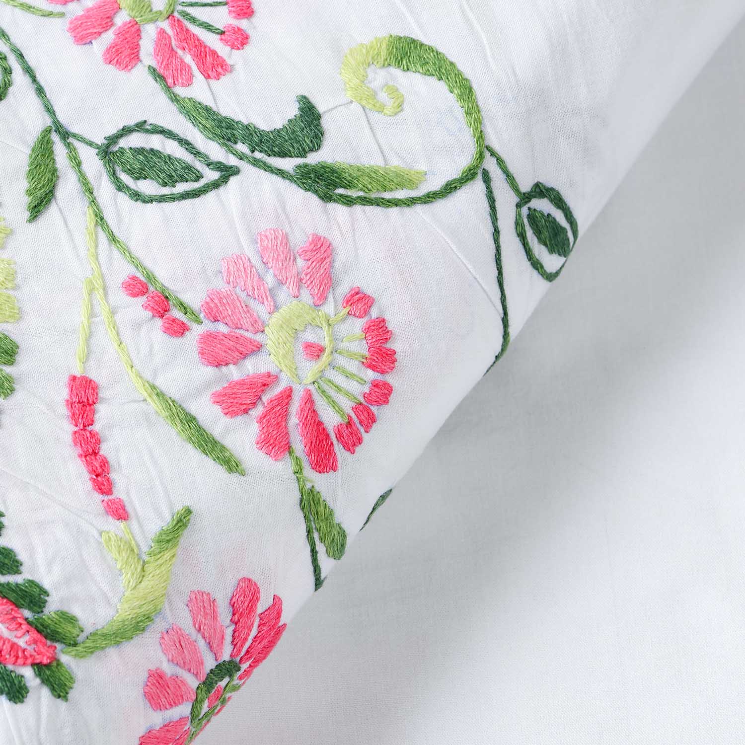 Close-up of Rangoon creeper floral embroidery and intricate cutwork on a handcrafted cotton table cloth