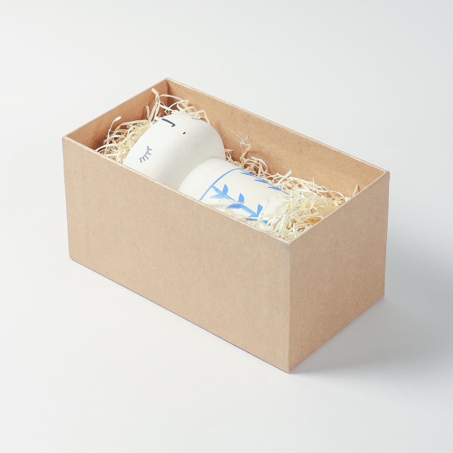 Rectangular gift box with a woven bamboo lid styled for festive gifting