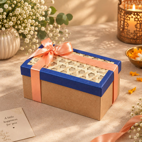 A rectangular gift hamper box with a natural bamboo lid filled with premium corporate gifts on a festive table setting.