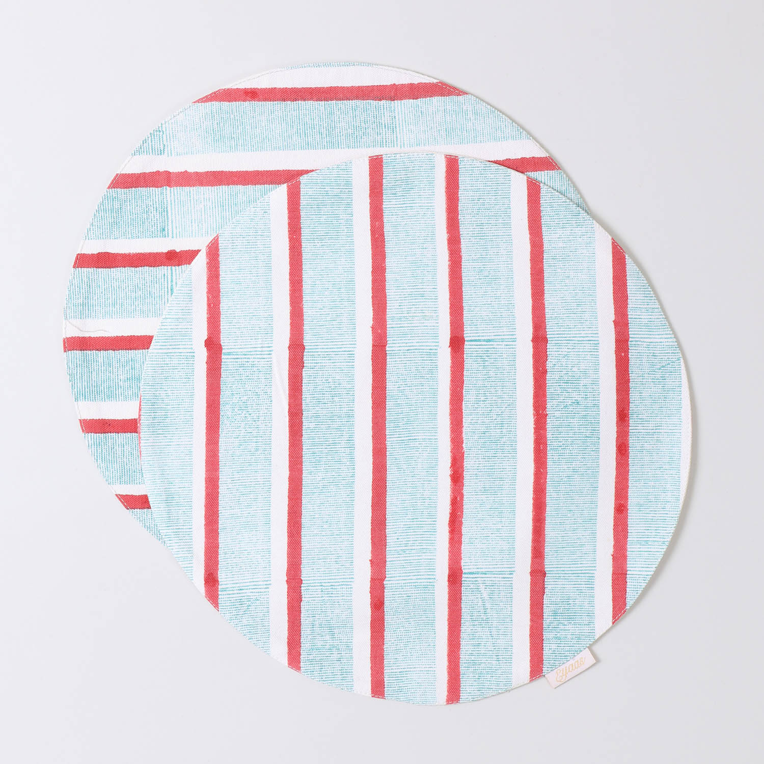 Set of 2 round cotton placemats featuring red and green stripe block printed designs displayed on a plain background