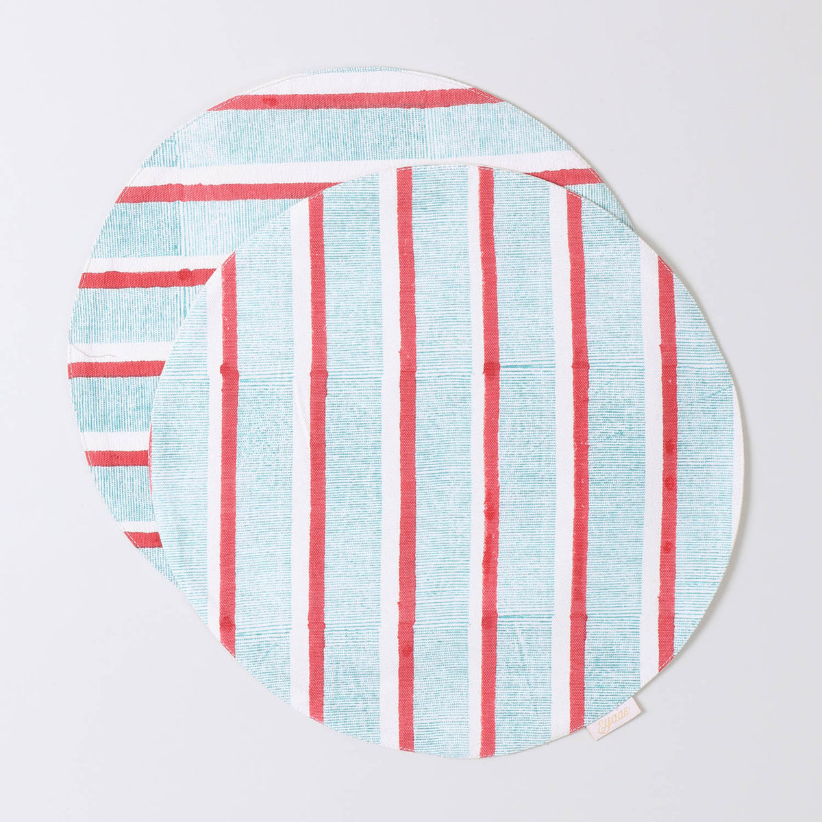 Set of 2 round cotton placemats featuring red and green stripe block printed designs displayed on a plain background