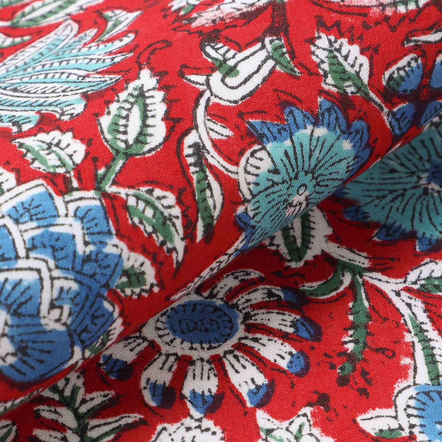 Detailed view of cotton placemat fabric with red and blue block print design, highlighting durable handcrafted construction