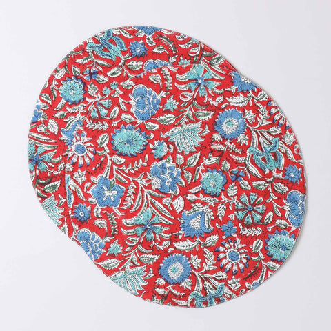 Set of 2 round cotton placemats featuring red and blue block printed designs displayed on a plain background
