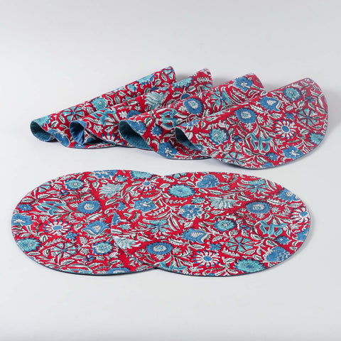 Six cotton placemats featuring traditional red and blue block printed patterns, handcrafted by Indian artisans for stylish table settings