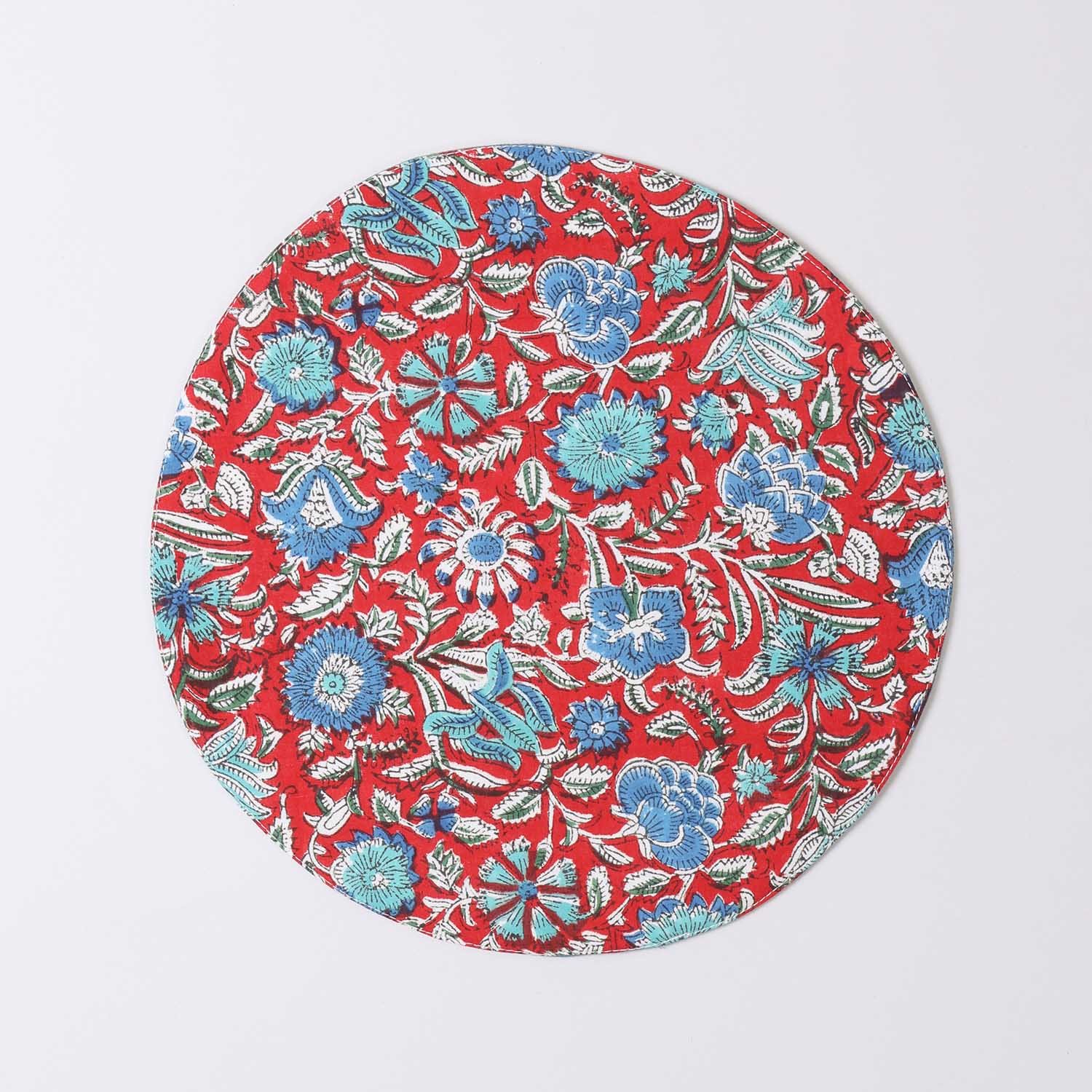 Round cotton table mat with red and blue block printed motifs handcrafted by Indian artisans