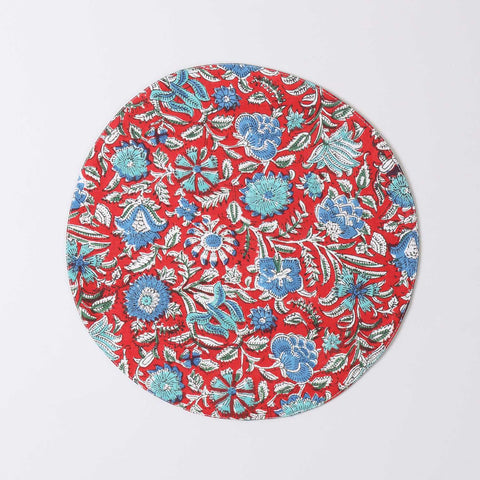 Round cotton table mat with red and blue block printed motifs handcrafted by Indian artisans