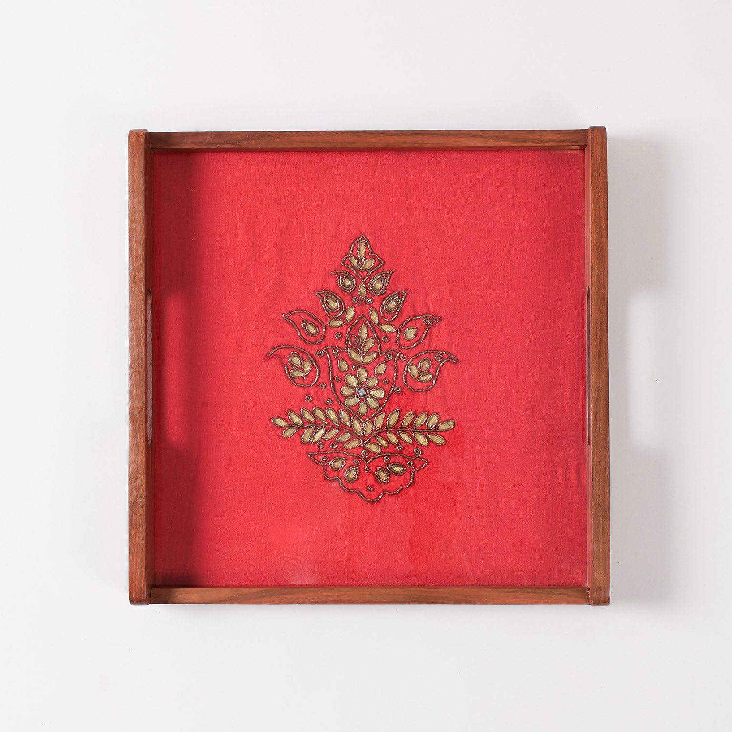 Top view of glass topped wooden serving tray highlighting reflective finish and detailed festive fabric artwork underneath