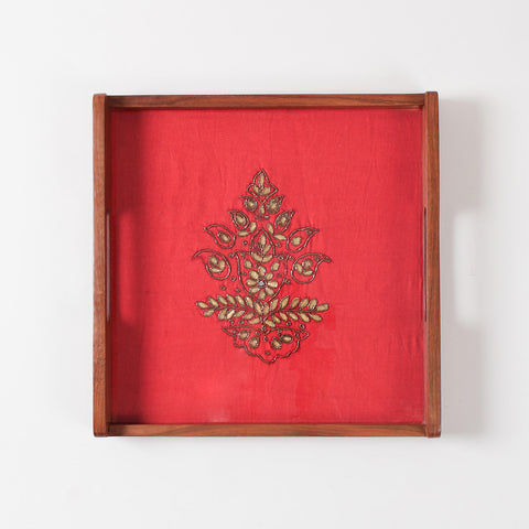 Top view of glass topped wooden serving tray highlighting reflective finish and detailed festive fabric artwork underneath