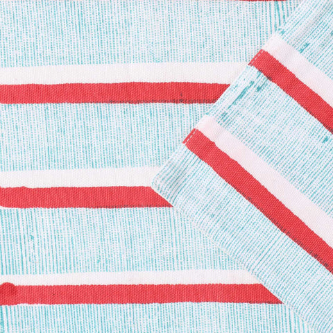 Detailed view of cotton canvas table linen with red and green stripe block print patterns showcasing handmade quality