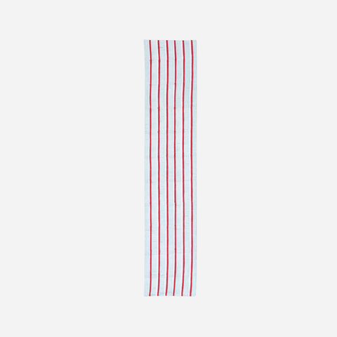  Full-length cotton table runner featuring red and green hand block printed stripe patterns on a white base, displayed on a plain background